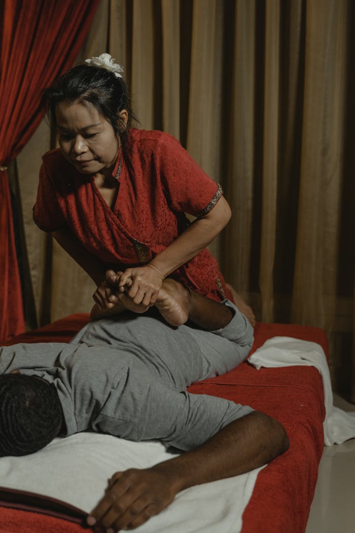 A soothing Thai massage in a tranquil room with an experienced therapist providing care.